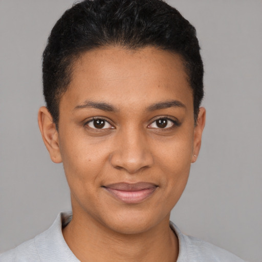 Joyful black young-adult female with short  brown hair and brown eyes