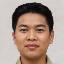 Joyful asian young-adult male with short  black hair and brown eyes