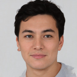 Joyful asian young-adult male with short  black hair and brown eyes