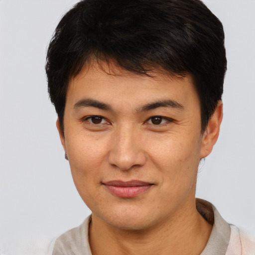 Joyful asian young-adult male with short  brown hair and brown eyes