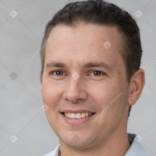 Joyful white adult male with short  brown hair and brown eyes