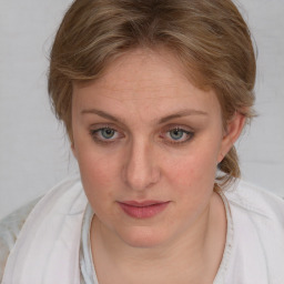 Joyful white young-adult female with medium  brown hair and blue eyes