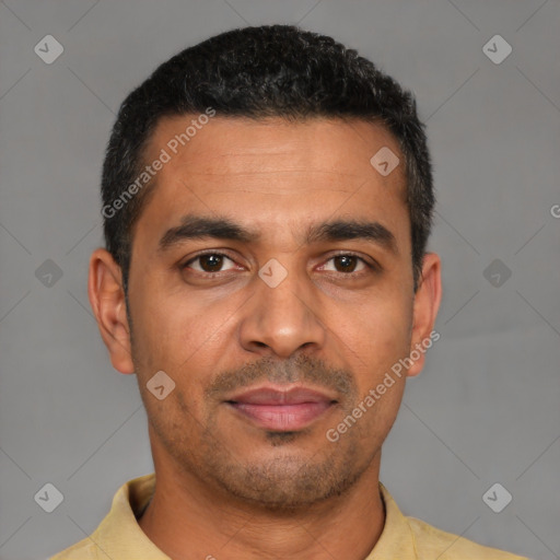Joyful latino adult male with short  black hair and brown eyes