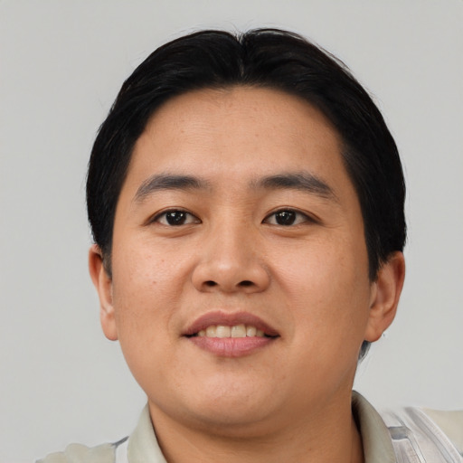 Joyful asian young-adult male with short  black hair and brown eyes