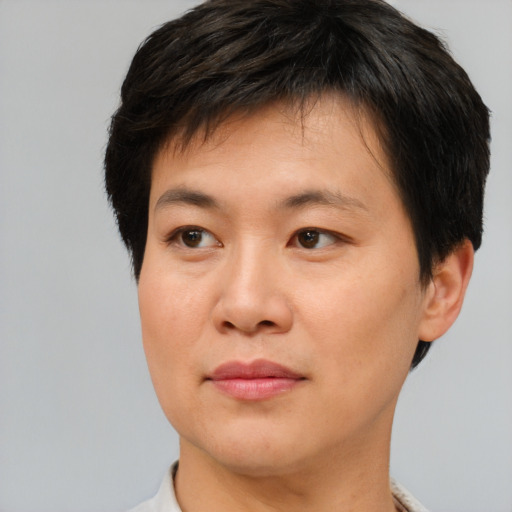 Joyful asian young-adult male with short  brown hair and brown eyes