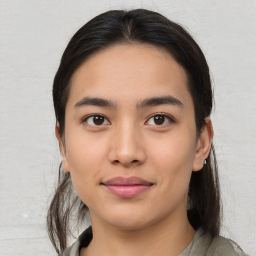 Joyful asian young-adult female with medium  brown hair and brown eyes