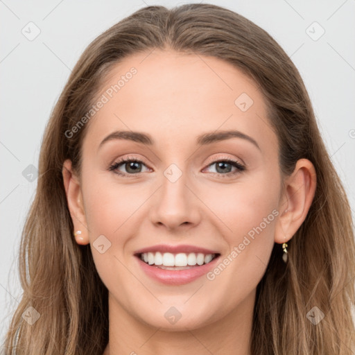 Joyful white young-adult female with long  brown hair and grey eyes