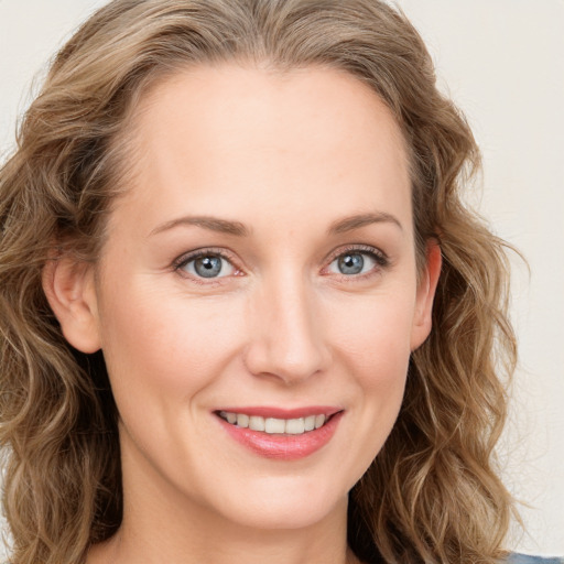 Joyful white young-adult female with long  brown hair and blue eyes