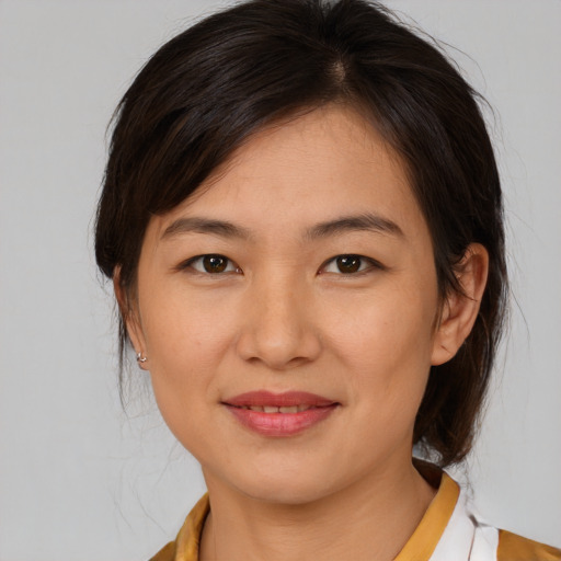 Joyful white young-adult female with medium  brown hair and brown eyes