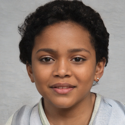 Joyful black child female with short  black hair and brown eyes