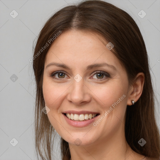 Joyful white young-adult female with long  brown hair and brown eyes