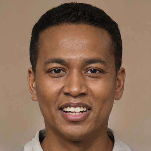 Joyful black young-adult male with short  black hair and brown eyes