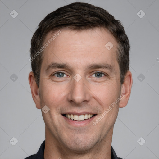 Joyful white adult male with short  brown hair and grey eyes