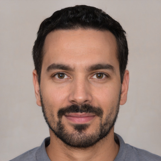 Joyful white young-adult male with short  black hair and brown eyes