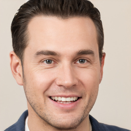 Joyful white young-adult male with short  brown hair and brown eyes