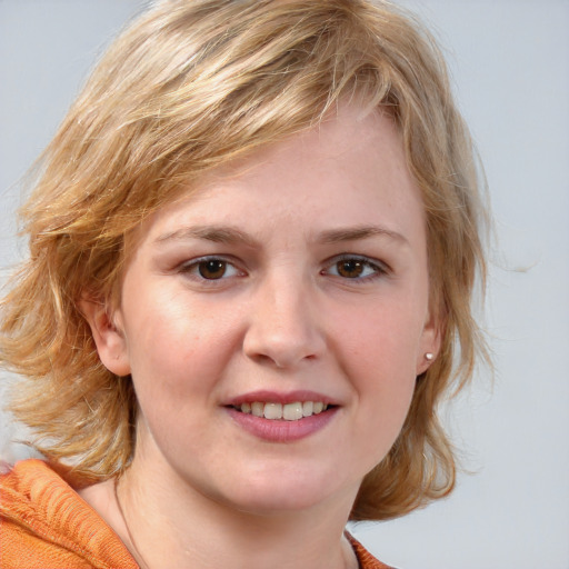 Joyful white young-adult female with medium  brown hair and blue eyes