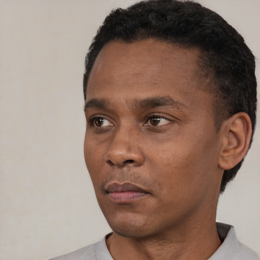 Neutral black young-adult male with short  black hair and brown eyes