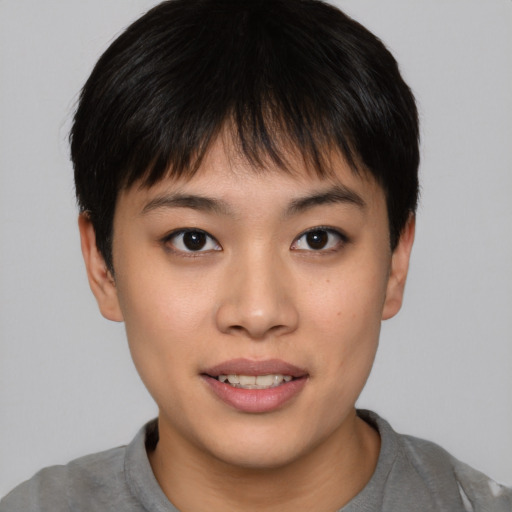 Joyful asian young-adult female with short  brown hair and brown eyes