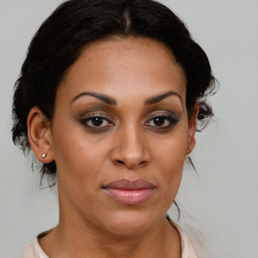 Joyful black young-adult female with medium  brown hair and brown eyes