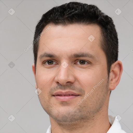 Joyful white young-adult male with short  black hair and brown eyes