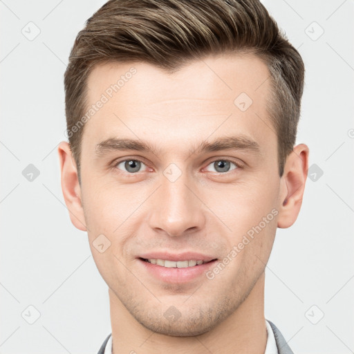 Joyful white young-adult male with short  brown hair and grey eyes