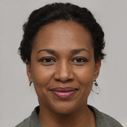 Joyful black adult female with short  brown hair and brown eyes