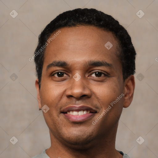 Joyful black young-adult male with short  black hair and brown eyes