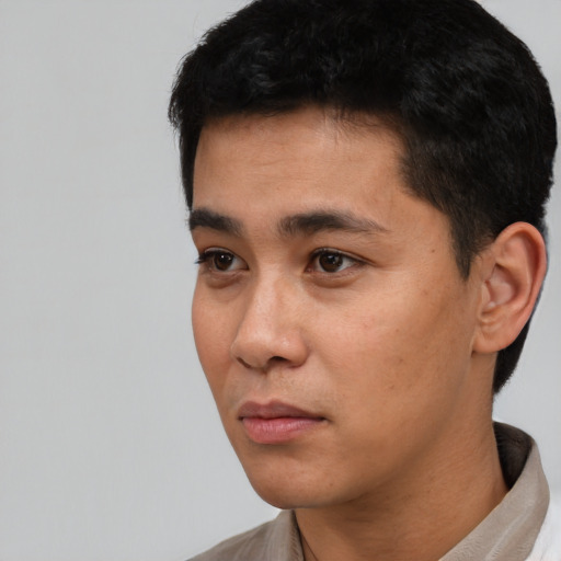 Neutral latino young-adult male with short  black hair and brown eyes