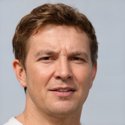 Joyful white adult male with short  brown hair and brown eyes