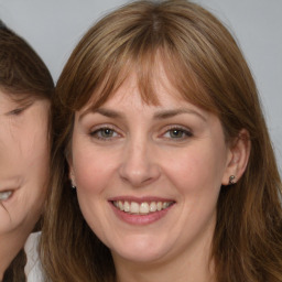 Joyful white adult female with medium  brown hair and grey eyes