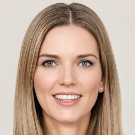 Joyful white young-adult female with long  brown hair and green eyes