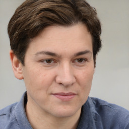 Joyful white adult male with short  brown hair and grey eyes