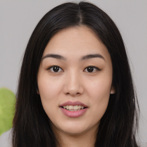 Joyful asian young-adult female with long  black hair and brown eyes