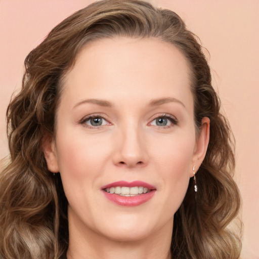 Joyful white young-adult female with long  brown hair and blue eyes