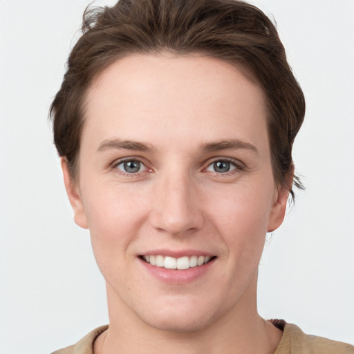 Joyful white young-adult female with short  brown hair and grey eyes