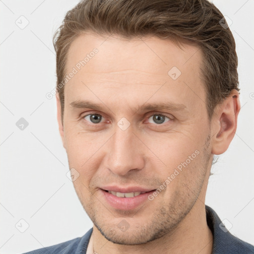 Joyful white young-adult male with short  brown hair and grey eyes