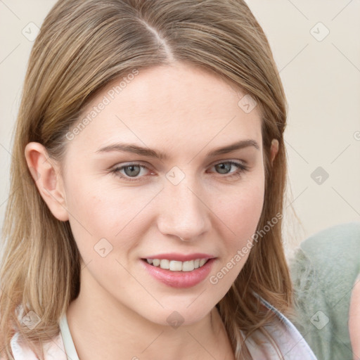 Joyful white young-adult female with long  brown hair and blue eyes