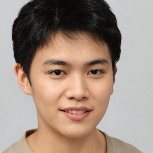 Joyful asian young-adult male with short  brown hair and brown eyes