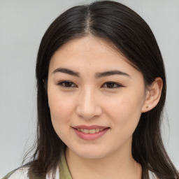 Joyful asian young-adult female with long  brown hair and brown eyes