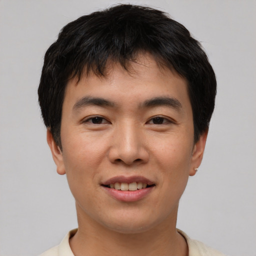 Joyful asian young-adult male with short  brown hair and brown eyes