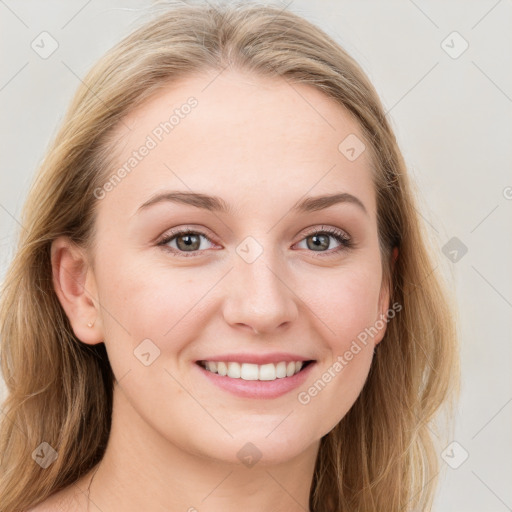 Joyful white young-adult female with long  brown hair and blue eyes