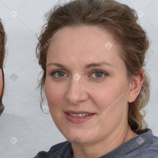 Joyful white adult female with medium  brown hair and blue eyes