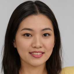 Joyful asian young-adult female with long  brown hair and brown eyes