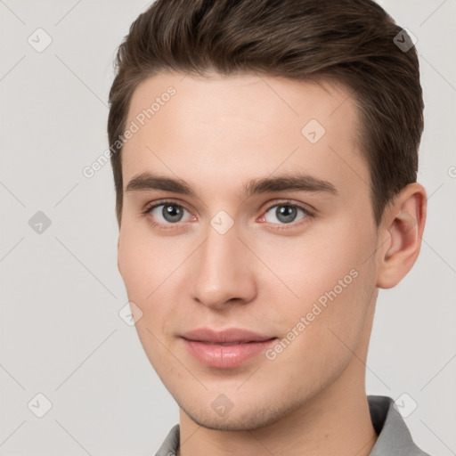 Joyful white young-adult male with short  brown hair and brown eyes