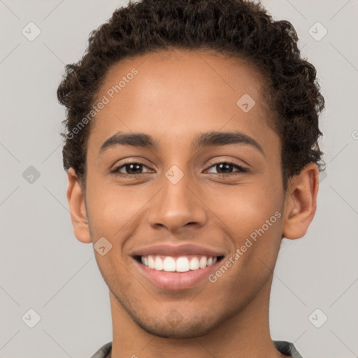 Joyful latino young-adult male with short  brown hair and brown eyes