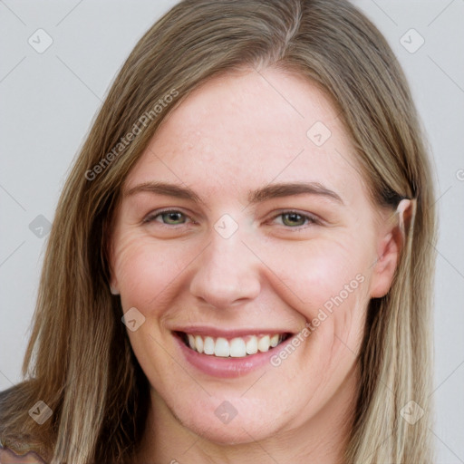 Joyful white young-adult female with long  brown hair and green eyes