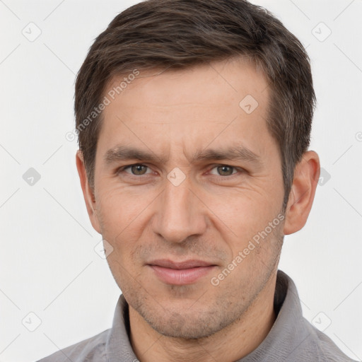 Joyful white adult male with short  brown hair and brown eyes