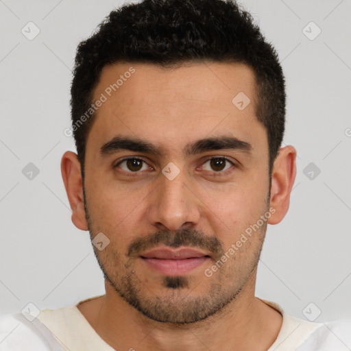 Joyful white young-adult male with short  black hair and brown eyes