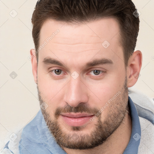 Joyful white young-adult male with short  brown hair and brown eyes