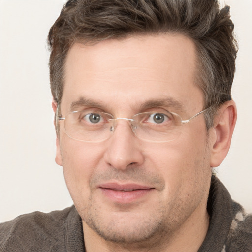 Joyful white adult male with short  brown hair and grey eyes